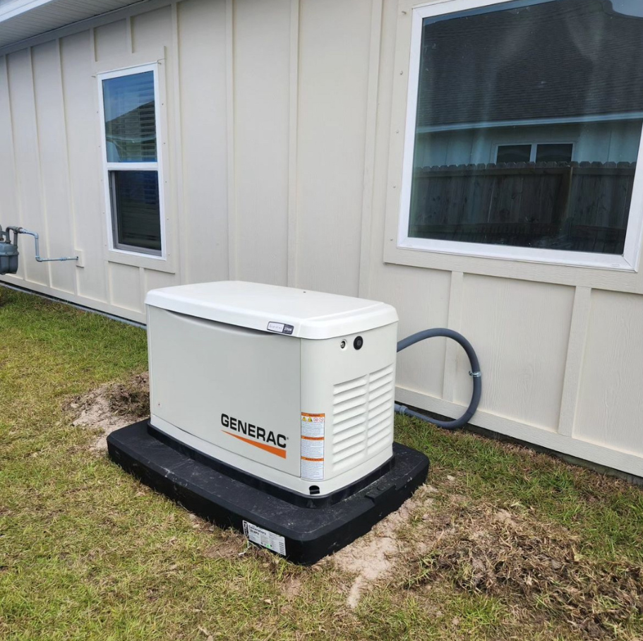 Baldwin County Generators technician next to an installed standby generator